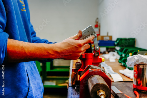 male worker adjusting clamp on vice