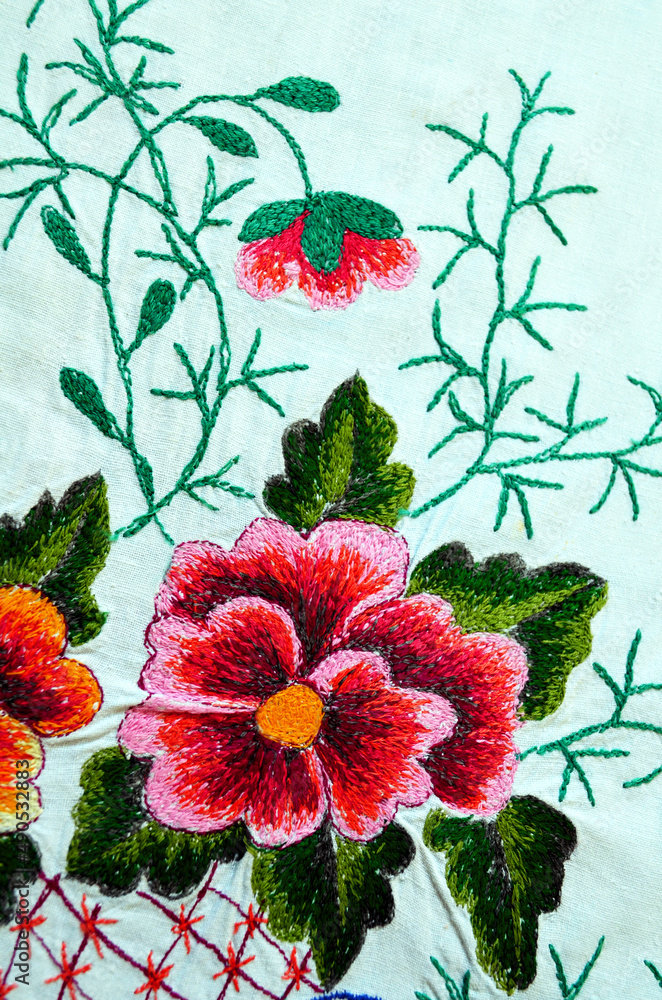 Embroidered red flower on white fabric, Ukrainian folk embroidery
