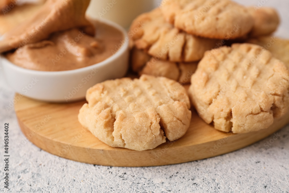 Wooden board with tasty peanut cookies on table, closeup Wooden board with tasty peanut cookies on table, closeup