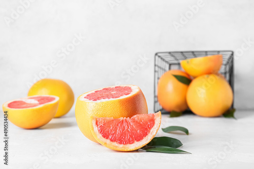 Fresh grapefruit pieces on light background