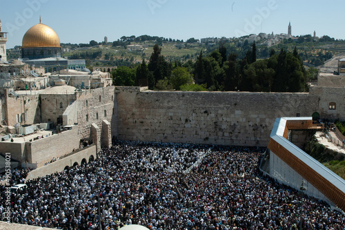 Jewish worshippers crowd into the prayer section below the Western Wall in Jerusalem for the Blessing of the Cohanim or priests given twice each year on the holidays of Passover and Sukkot. photo
