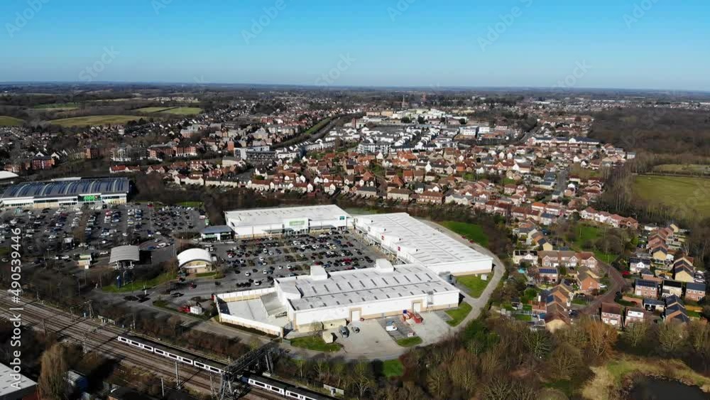 Aerial view of a train passing by a superstore in Colchester Aerial view of a train passing by a superstore in Colchester