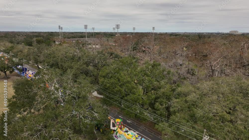 Floats getting ready for parade aerial wive with a football stadium reveal in the background