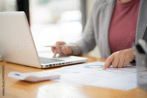 Business Woman working by using laptop computer Hands typing on a keyboard. Professional investor working new start up project. business planning in office. Technology business Concept