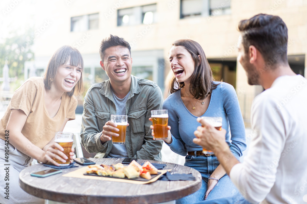 Happy multiracial friends group drinking beer at brewery pub restaurant - Friendship concept with young people having fun and laughing together - Focus on asian man Happy multiracial friends group drinking beer at brewery pub restaurant - Friendship concept with young people having fun and laughing together - Focus on asian man