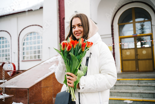 girl with tulip flowers at the train station