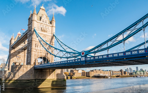 London Tower Bridge. A view from the south bank of the famous landmark crossing the River Thames with Wapping warehouses on the north bank visible.