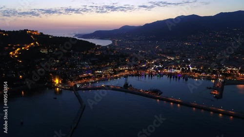 Aerial high angle view of the Alanya City Center during blue hour Colourful City lights and orange sky