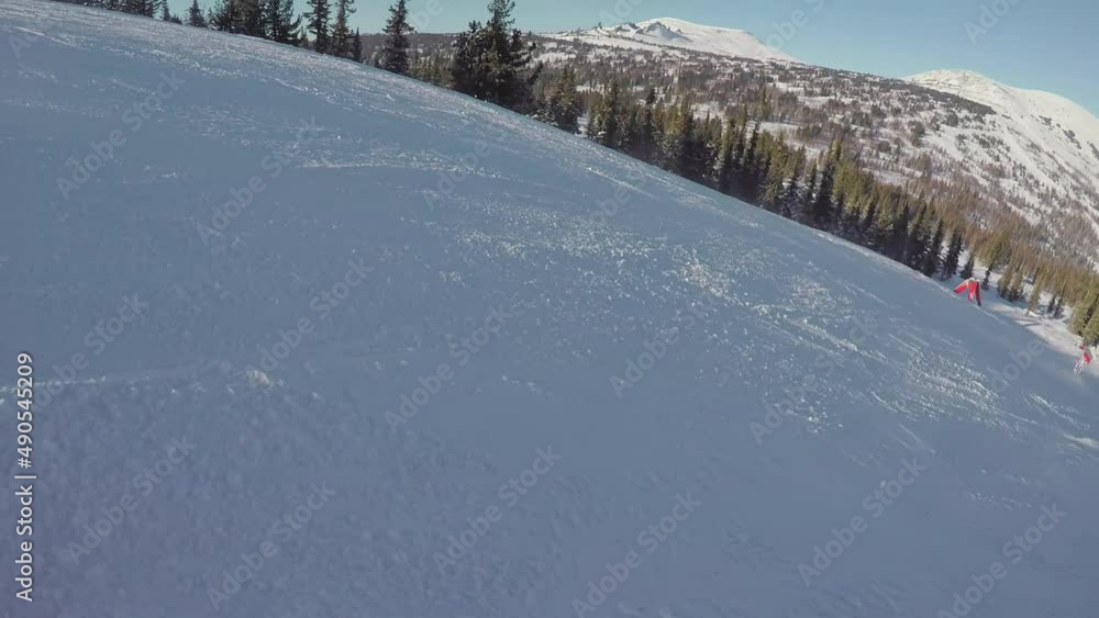 Snowboarding or skiing on a winter snowy slope. Ski resort, winter sport. Snowboarding or skiing on a winter snowy slope. Ski resort, winter sport.