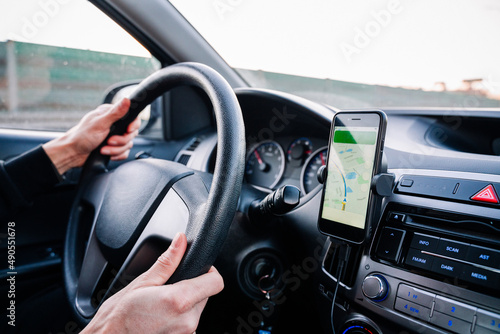 Gps device map system. Global positioning system on smartphone screen in auto car on travel road. GPS vehicle navigator driver device.