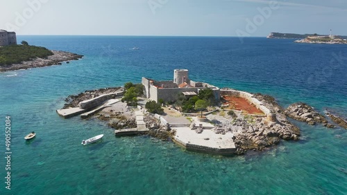 Castle on the island of Otocic Gospa in the Bay of Kotor. Montenegro. Top view of the island with a fortress. Drone. Pleasure boats in the bay. 
 photo