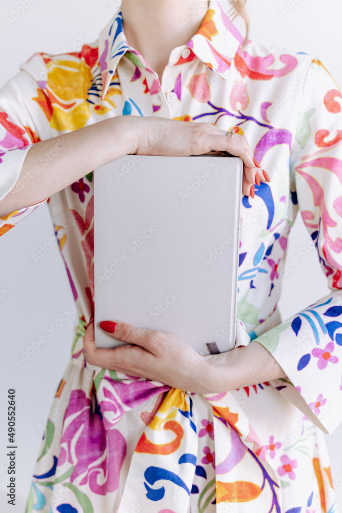 Fototapeta premium Woman Holding Blank Notebook Copy Space Photo. Young Girl Wearing Elegant Attractive Dress Hold Educational Book or Copybook Stationery Accessory for Writing and Learning Lecture Lesson