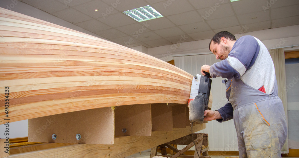 Carpenter making wooden boat in carpenter workshop. Carpenter making wooden boat in carpenter workshop.