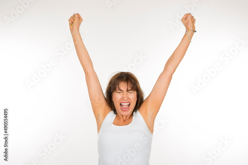 portrait adult woman with raised arms on a white background