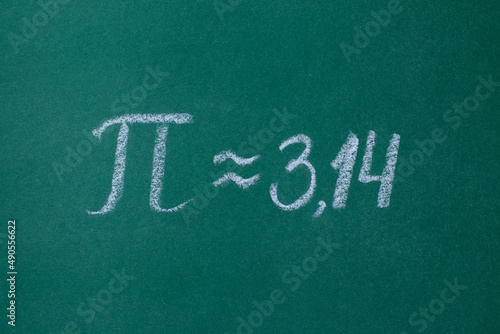 The Greek letter "Pi" on the green blackboard is written in white chalk horizontal photo