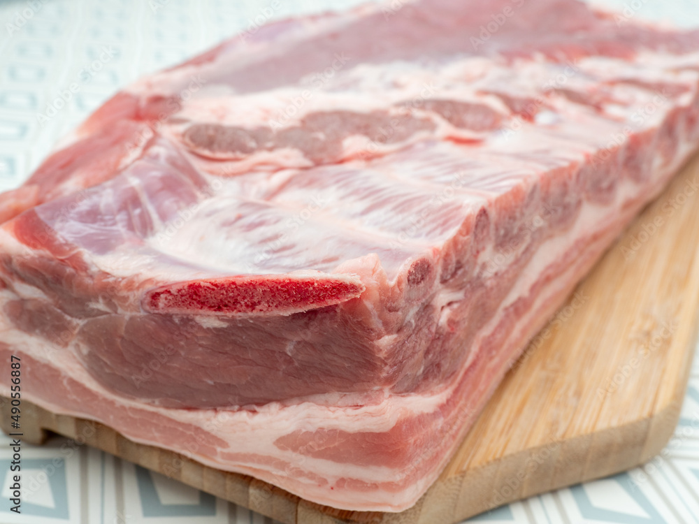Raw pork meat on a cutting board. Raw meat Raw pork meat on a cutting board. Raw meat