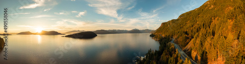 Aerial Panoramic View of Sea to Sky Highway on Pacific Ocean West Coast. Sunny Winter Colorful Sunset. Located in Howe Sound between Vancouver and Squamish, British Columbia, Canada.