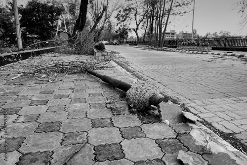 Super cyclone Amphan uprooted Trifala street light which fell and blocked pavement. The devastation has made many damages on the state. Shot at Howrah, West Bengal, India . Black and white. photo