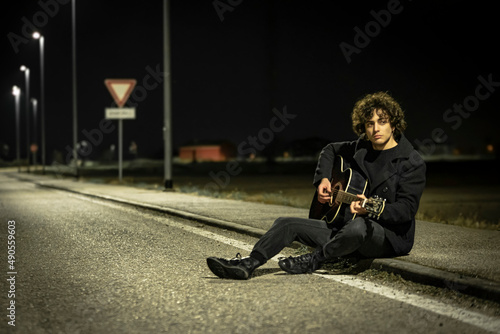 Fototapeta Naklejka Na Ścianę i Meble -  Acoustic Guitar Musician Night Sidewalk