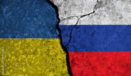 Political relationship between Ukraine and russia. National flags on cracked concrete background