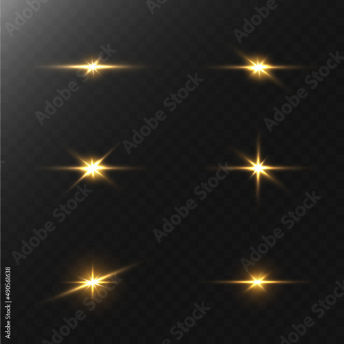 A set of flares, bright lights and sparkles on a black background. Golden flashes and glare. Abstract golden isolated lights Bright rays of light. Glowing lines.