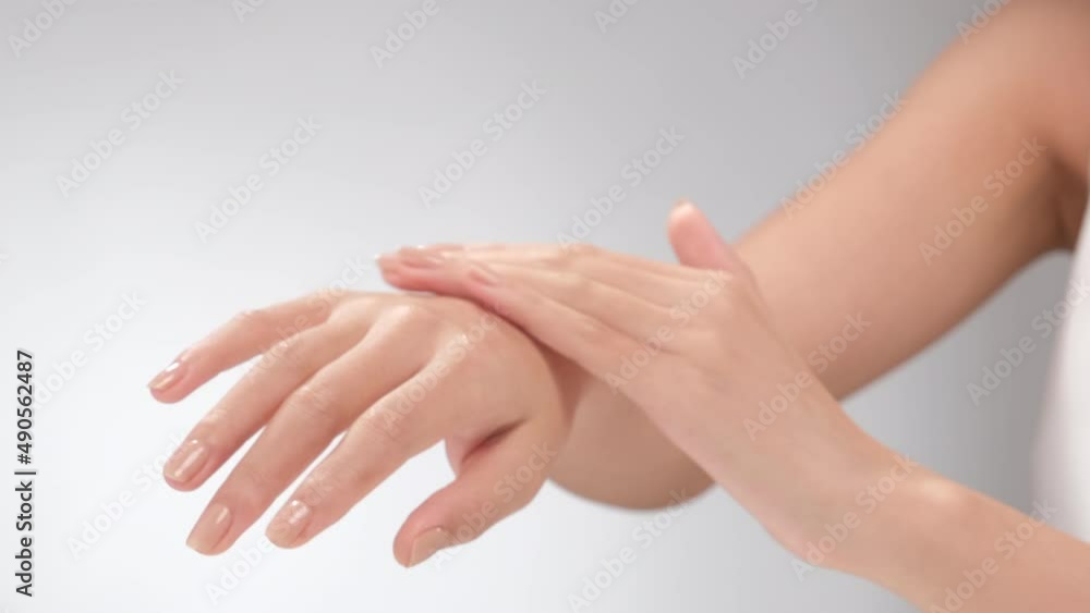 A moment of women using cream on back of the hand in white background for cosmetic advertising A moment of women using cream on back of the hand in white background for cosmetic advertising