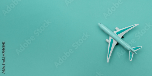 Model plane on pastel color background. Miniature airplane. Copy space. Banner.