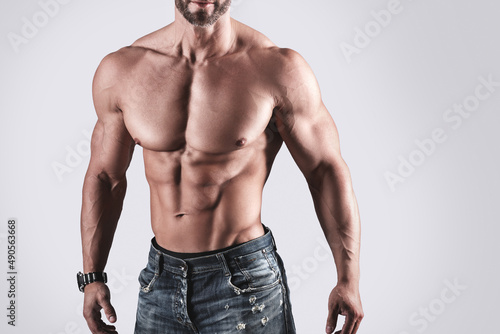Muscular man bodybuilder wearing jeans