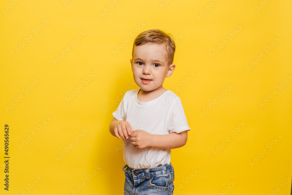 Portrait of a cute laughing little boy on a yellow background. Copy space. Portrait of a cute laughing little boy on a yellow background. Copy space.