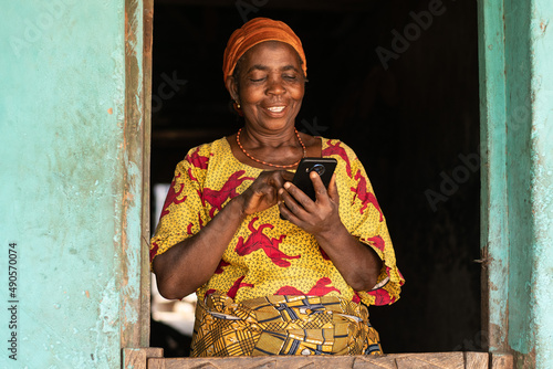 smiling elderly african woman using her phone