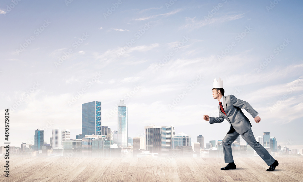 King businessman in elegant suit running and modern cityscape at background King businessman in elegant suit running and modern cityscape at background