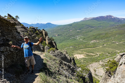 A man with a child on the background of the Chatyr-Dag plateau from the Demerji mountain range in Crimea. Russia.