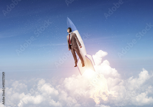 Obraz na plátně Business person in aviator hat flying on rocket