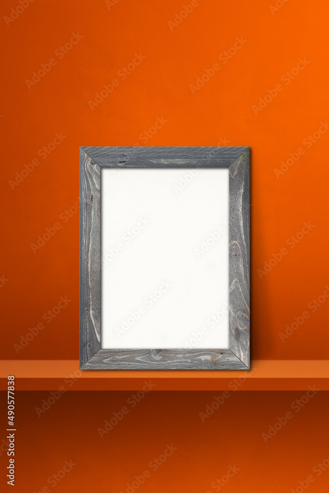 Wooden picture frame leaning on orange shelf. 3d illustration. Vertical background Wooden picture frame leaning on orange shelf. 3d illustration. Vertical background