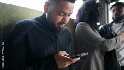 A young black black staring at phone screen