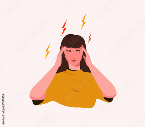 Woman holds her head with her hands and suffers from a headache