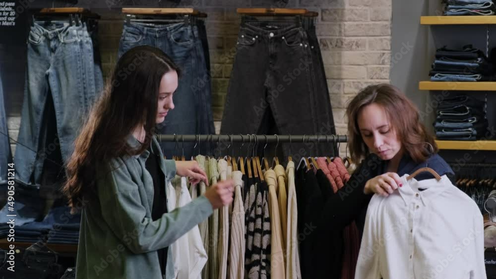 The stylist helps the girl to make a wardrobe The stylist helps the girl to make a wardrobe