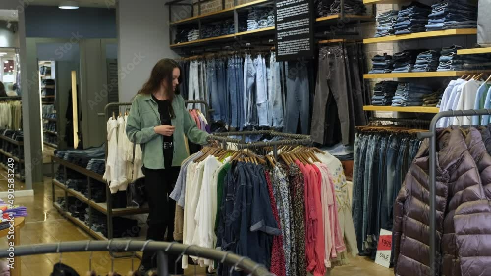 A young lady walks around the mall in search of beautiful clothes. A young lady walks around the mall in search of beautiful clothes.