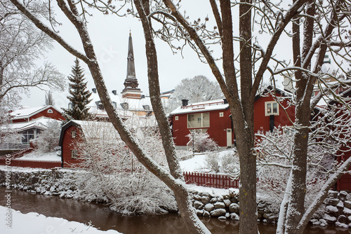 Bild auf Leinwand White winter in Sweden, Swedish style traditional red houses, pointed spire of c