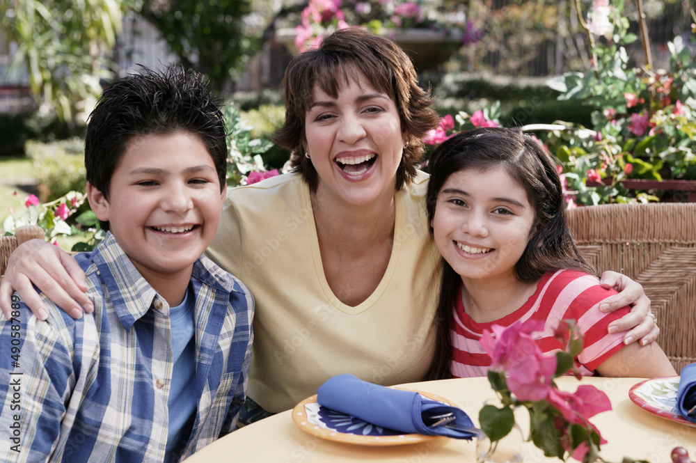 Hispanic mother and children at table Hispanic mother and children at table