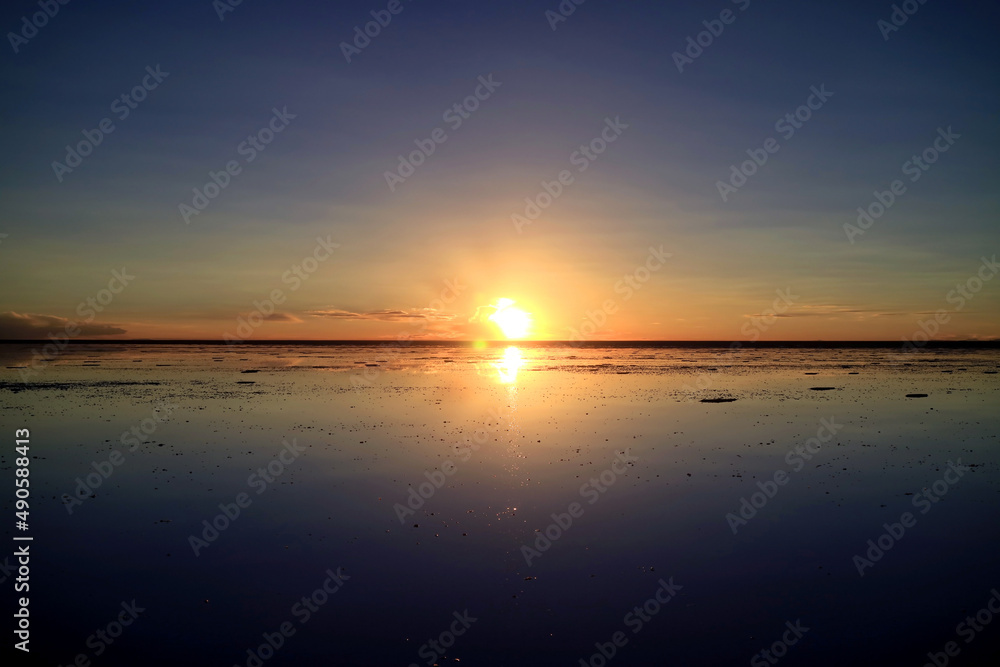 Obraz premium Stunning sunset reflection on the flooded Uyuni Salt Flats, UNESCO World Heritage Site in Bolivia, South America