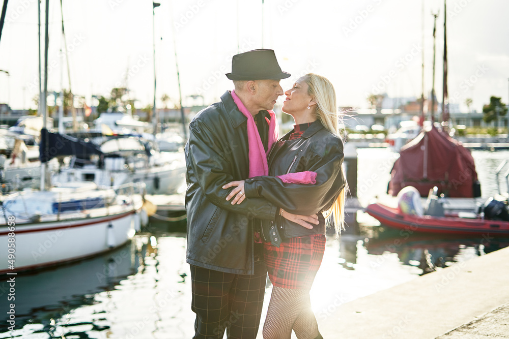 Romantic middle-aged couple strolling along the marina Romantic middle-aged couple strolling along the marina