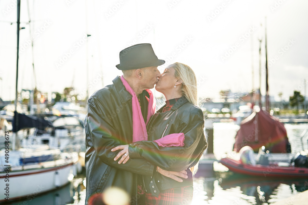 Romantic middle-aged couple kissing in the harbor