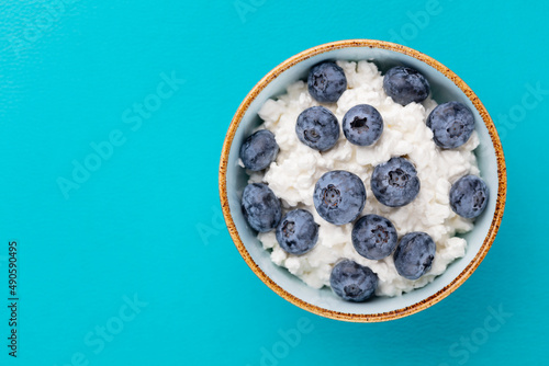 Cottage cheese with blueberry, fresh berries, keto healthy breakfast concept, top view.