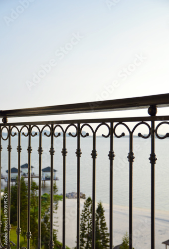 Hotel room balcony fences view to white sand seashore of Turtle Island, Ha Long, Vietnam