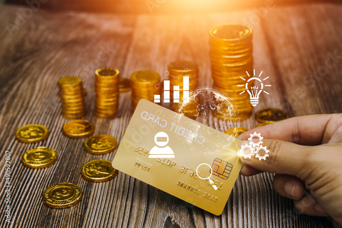 The person holds a gold credit card and is filling out their credit card information to pay for goods online, credit cards can pay for goods and services both in the storefront and online shopping.