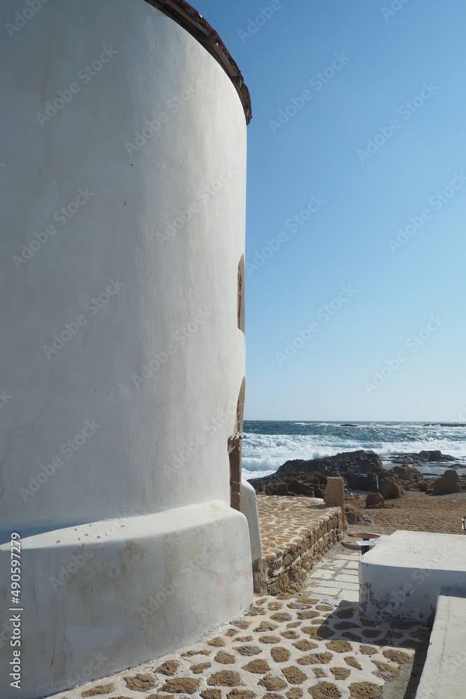 Obraz premium Famous landmark windmill near Molos area overlooking the Aegean deep blue sea, Skiros island, Sporades, Greece