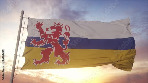 Limburg flag, Netherlands, waving in the wind, sky and sun background photo