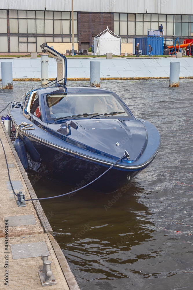 Naklejka premium modern motor boat parked on the pier of the Russian city of St. Petersburg, Russia
