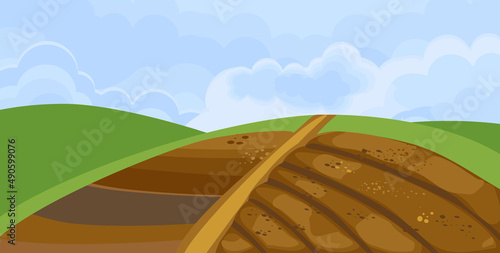 Landscape with freshly plowed field (arable land) and blue sky